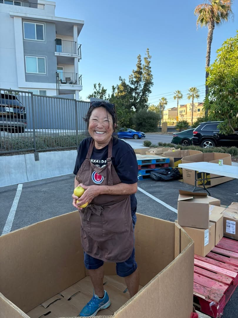Placeholder image showing volunteers, food boxes, or distribution support